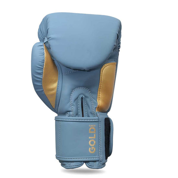 The SMAI Gold Series Boxing Glove in Light Blue/Gold features gold accents and "GOLD" printed near the wrist strap. Designed to deliver exceptional shock protection and wrist support, this glove is photographed against a white background.