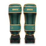 The SMAI Gold Series Muay Thai Shin Guards in Green/Gold are marked "LEFT" and "RIGHT" for easy identification. Designed with adjustable straps for a secure fit, these shin guards feature high-density foam padding and multi-layer EVA protection, delivering maximum safety and superior comfort during training or competition.