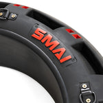 Close-up of the 80kg Strongman Functional Tyre by SMAI, featuring a black design with red highlights and the brand name in bold red letters. The tyre includes metal buckles, straps, and chain handles, perfect for intense boot camp workouts.
