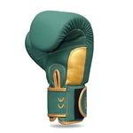 The SMAI Gold Series Boxing Glove in Green/Gold features visible stitching and stands upright against a white background. Its Velcro-secured wrist strap displays "12 OZ" and provides excellent wrist support for enhanced comfort during training.