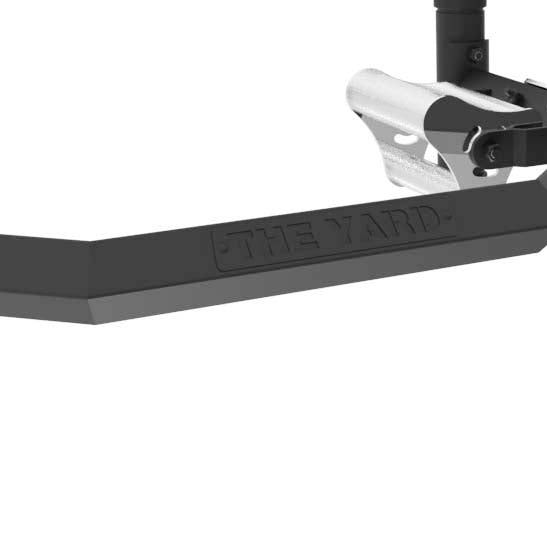 Close-up of the SMAI The Yard - Open Hex Trap Bar with Tri Grip Rotating Handle in black and silver metal, featuring "THE YARD" engraving, handle, and structural components.