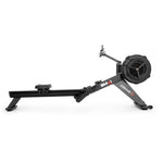 Black SMAI AirMag X Rower with a large flywheel, a sliding seat, and a mounted tablet holder for advanced rowing.