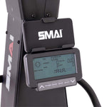 Close-up of an SMAI AirMag X Skier console displaying performance metrics including time, distance, and pulse, with navigation buttons below the screen.