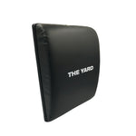 The SMAI The Yard - Ab Mat - Cross Training is a black rectangular mat with "THE YARD" in white on the front, featuring slightly rounded edges and soft cushioning for lower back support during workouts.