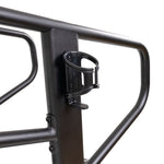 Close-up of a black metal bike rack with a black water bottle holder, both as durable as the SMAI Air Runner Curved Treadmill with Adjustable Resistance. The rack has sturdy tubular bars and a vertical support where the holder is attached.