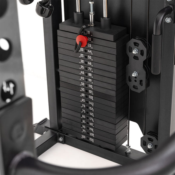 Close-up of the SMAI All in 1 Functional Trainer’s weight stack with black plates, numbered kg labels, and a red pin at 22 kg. Metal rods and cables are visible—ideal for any home gym or functional training setup.