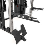 Close-up of the SMAI All in 1 Functional Trainer, featuring metal weight stacks, guide rods, adjustment knobs, and a diamond-plate angled footplate—engineered for commercial-grade performance on a white background.