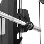 Close-up of the SMAI All in 1 Functional Trainer’s metal barbell on a black hook, with cables and a vertical guide rail in the background, showcasing commercial-grade performance for home gym use.