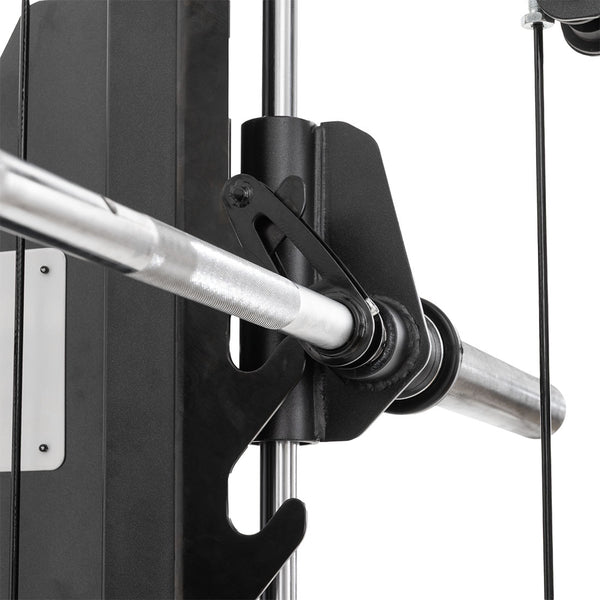 Close-up of the SMAI All in 1 Functional Trainer’s metal barbell on a black hook, with cables and a vertical guide rail in the background, showcasing commercial-grade performance for home gym use.