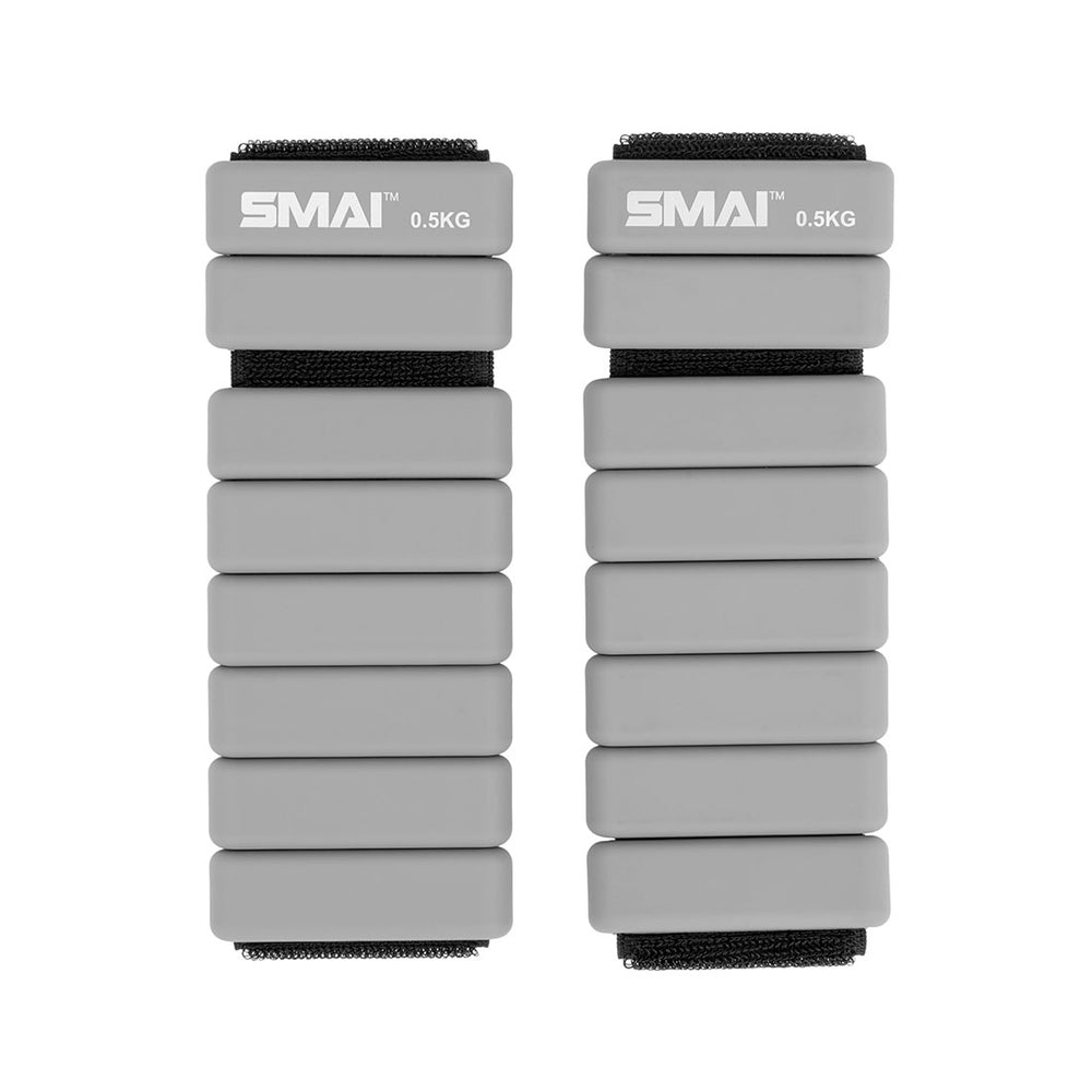 A pair of SMAI Weighted Ankle / Wrist Bracelets 0.5KG in grey, featuring black straps and "SMAI 0.5KG" labeling—ideal for adding resistance to your workouts.