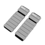 The SMAI Weighted Ankle / Wrist Bracelets 0.5KG (Pair) in grey feature adjustable black straps and are shown side by side on a white background—perfect for resistance training.