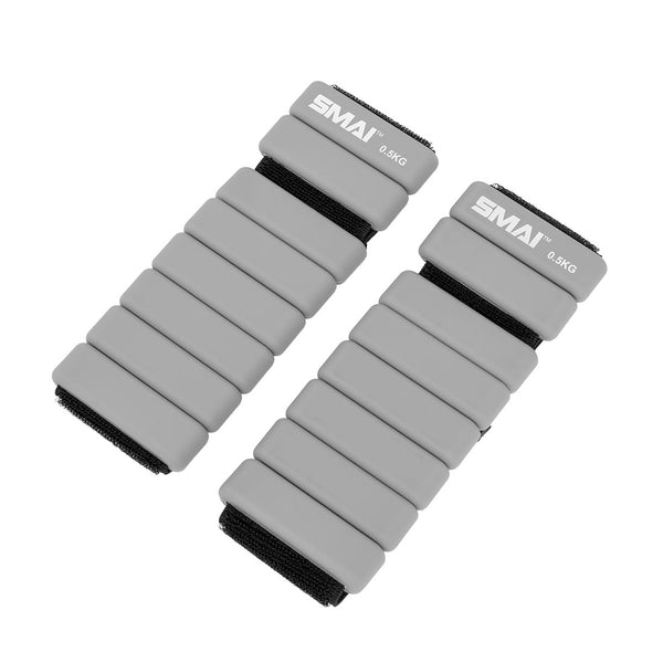 The SMAI Weighted Ankle / Wrist Bracelets 0.5KG (Pair) in grey feature adjustable black straps and are shown side by side on a white background—perfect for resistance training.