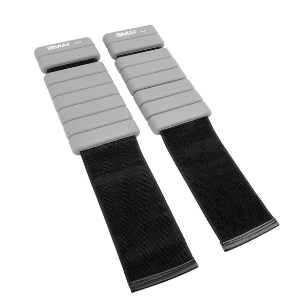 The SMAI Weighted Ankle/Wrist Bracelets 1KG (Pair) in grey feature adjustable Velcro straps and padded segments, making them ideal for resistance training. Shown on a white background.