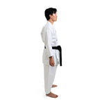 A person stands in side profile, showcasing their SMAI WKF Karate Uniform - Premium Kata Gi - Arashi with a Japanese style cut. The white gi is WKF Approved and paired with a black belt on a plain white background. Barefoot, hands by their sides, they exude calm confidence.