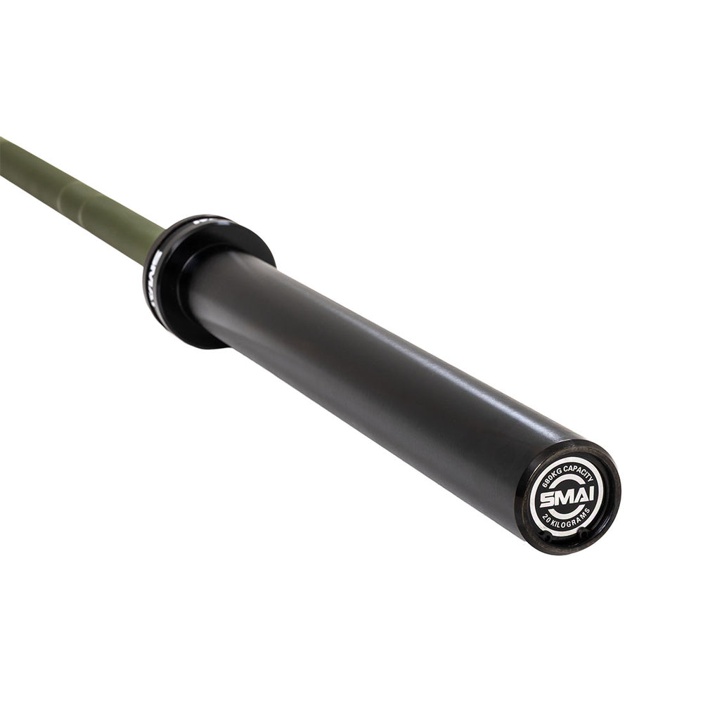 A close-up of the SMAI Barbell - Army Green Ceramic Coat - 20kg shows the black sleeve and branded end cap. This barbell is rust resistant, durable, and stylish.