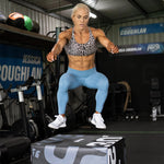 Woman jumping onto a SMAI Plyometric box