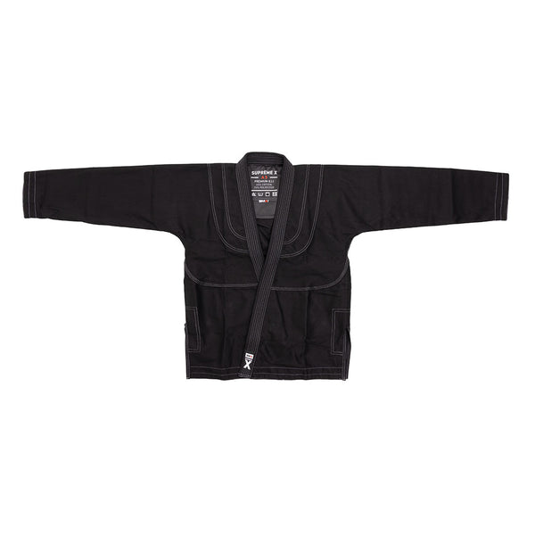 The SMAI Supreme X Brazilian Jiu Jitsu Uniform - Black jacket, made from durable pearl weave fabric with white stitching, wide sleeves, a thick collar, and visible chest patches and label, is displayed on a white background.