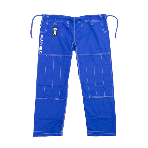 The SMAI Supreme X Brazilian Jiu Jitsu Uniform - Blue features bright blue pearl weave pants with reinforced stitching, a drawstring waist, “SUPREMEX” in white on the left leg, and a black and white tag near the waistband.