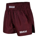The SMAI Muay Thai Shorts - Burgundy are unisex satin polyester shorts featuring “SMAI” in white on the waistband and lower left leg. With an elastic waistband and side slits for enhanced movement, they are designed to provide comfort and freedom during training or competition.