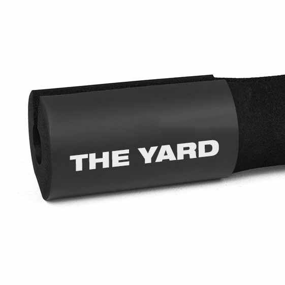 A close-up of the SMAI The Yard - Barbell Pad / Hip Thruster Pad, featuring black foam and “THE YARD” printed in bold white letters.