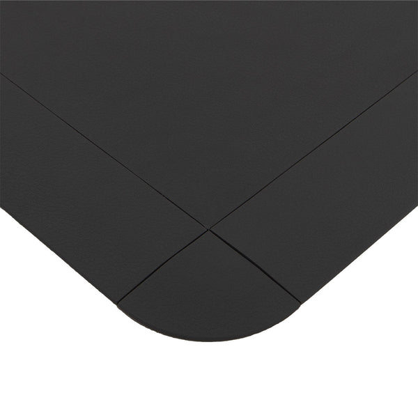 A close-up of the TPE Gym Flooring Edge / Corner Accessories by No Sync To Channel Engine, featuring a black, textured surface that mimics premium rubber gym flooring. The image highlights a rounded corner and overlapping seams with a smooth, durable finish and subtle grain pattern, emphasizing the geometric design created by the intersecting edges.