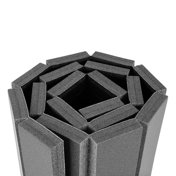 The SMAI Roll Out Workout Mat – Dollamur Flexi Roll in black features angular, geometric folds in a spiral pattern, crafted with Flexi-Roll technology and tatami-textured vinyl, shown against a white background.