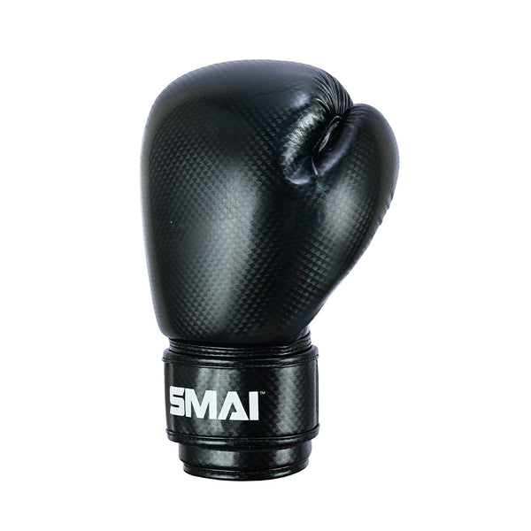 The PRE ORDER: Essentials Kids Boxing Glove - Black by SMAI is a single black children's glove with a textured surface and "SMAI" in white on the wrist strap, displayed against a plain white background.