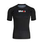 The SMAI Short Sleeve Rash Guard - Black is an athletic compression shirt with white and red branding on the chest, ideal for BJJ or no-gi grappling, shown on a plain white background.