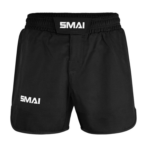 The SMAI MMA Grappling Shorts - Black feature an elastic waistband, Velcro closure, and polycotton fabric. "SMAI" is printed in white on the waistband and lower left leg. A stretch gusset enhances flexibility in this functional design.