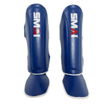 The Essentials Muay Thai Shin Instep Guard - Blue by SMAI features blue synthetic leather, white trim, and the SMAI logo in white and red, offering superior shin and instep protection for martial arts training.
