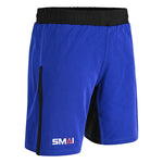 SMAI Hybrid MMA Grappling Shorts in black and blue feature a black elastic waistband, black side accents, and the SMAI logo in white, orange, and gray on the left leg. Perfect for durable training.