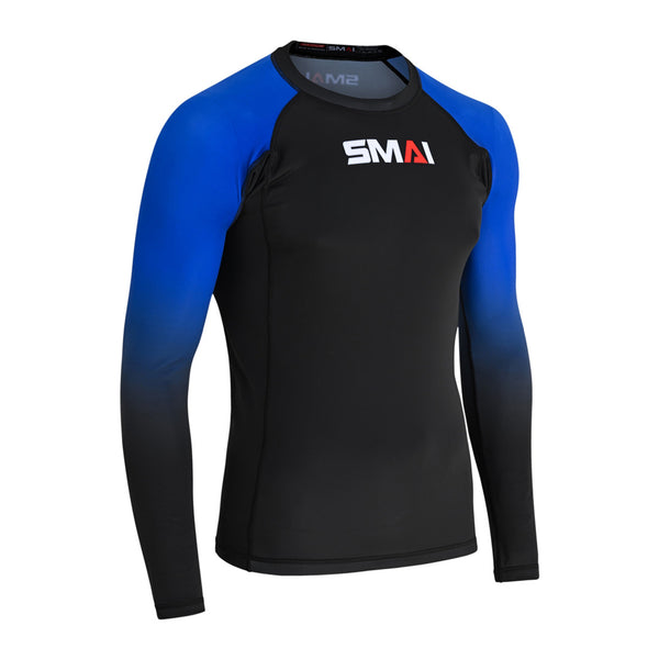 The SMAI Long Sleeve Rash Guard - Blue features blue sleeves fading to black, a black body, and "SMAI" chest print—perfect for no-gi grappling with advanced compression technology.