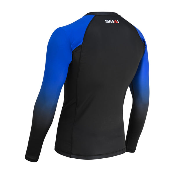 The SMAI Long Sleeve Rash Guard - Blue features a black body with blue gradient sleeves, compression technology for no-gi grappling, and the SMAI logo on the upper back.