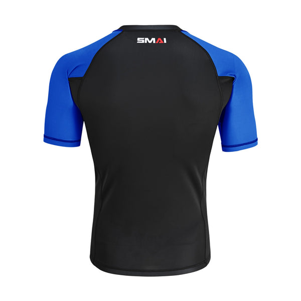 The SMAI Short Sleeve Rash Guard - Blue is a black and blue compression shirt shown from the back, ideal for BJJ, with the SMAI logo at the upper center near the neckline.