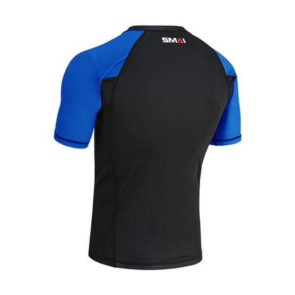 The SMAI Short Sleeve Rash Guard - Blue features black fabric on the main body, bright blue sleeves, and "SMAI" in white and red near the neck—ideal as a compression shirt for no-gi grappling.