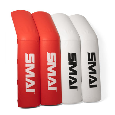 Two red and two white boxing ring corner pads, made by SMAI, feature medium-density foam and durable vinyl covers with the brand name printed in bold black letters.