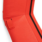 Close-up of the SMAI Boxing Ring Corner Pads in red and white, featuring a black zipper and side strap, reminiscent of its leather texture and visible seam stitching.