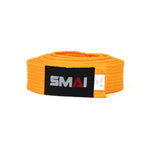 The SMAI Martial Arts Belt Single Colour, perfect for karate enthusiasts, is neatly rolled in orange. It features a black patch with "SMAI" and a small white tag indicating its size as "3.