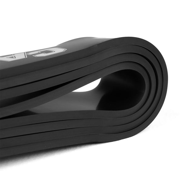 A close-up of the Combine Air Rubber Resistance Band - 75lb from SMAI displays its intricate layers on a white background, with its partially visible logo adding sleekness to this essential fitness companion.