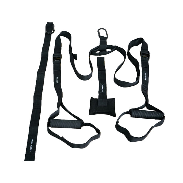 SMAI's The Yard - Suspension Trainer - GTS features black adjustable straps with handles, buckles, and foot cradles. This portable fitness equipment is perfect for functional strength and bodyweight resistance training.