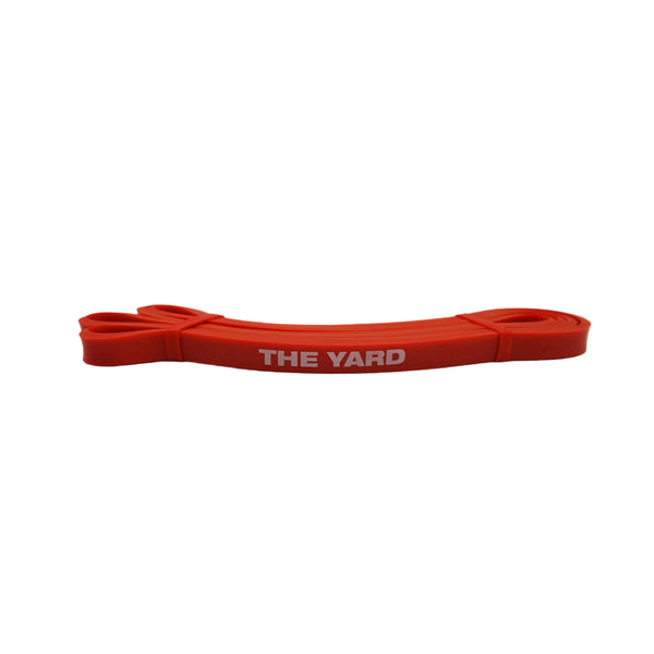 The SMAI The Yard Exercise Resistance Band (10lb/4.5kg) in red features its bold white logo, displayed against a plain white background.