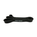 The SMAI The Yard Exercise Resistance Band - 25lb/11.3kg in black displays "THE YARD" in white text and is coiled neatly on a plain white background—a high-quality resistance band ideal for strength training.
