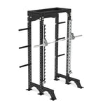 The SMAI Half Power Rack with Smith Machine from the Vanta Series features adjustable safety bars and convenient weight storage pegs on the sides. It comes equipped with a barbell and weights, offering an ideal setup for your intense workouts.