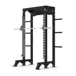 The Half Power Rack with Smith Machine from the SMAI Vanta Series boasts a black frame, adjustable barbell supports, and side weight storage pegs. Its robust design includes multiple holes for customization, making it ideal for strength training at home or in a gym.