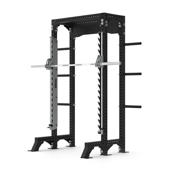 The Half Power Rack with Smith Machine from the SMAI Vanta Series boasts a black frame, adjustable barbell supports, and side weight storage pegs. Its robust design includes multiple holes for customization, making it ideal for strength training at home or in a gym.