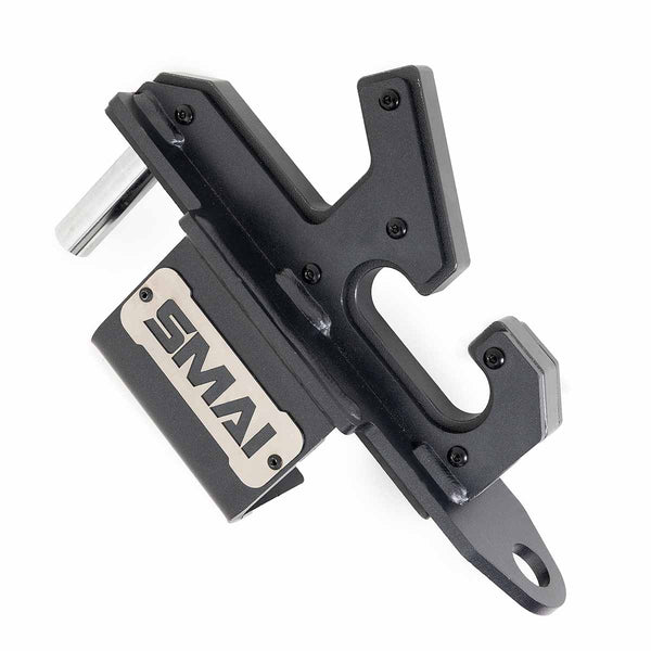 The SMAI 2-in-1 Isometric Cup/J-Hook Utility for Vanta Series Power Racks is a black metal wall-mounted bracket with a silver logo plaque, designed to hold gym accessories or j-hooks compatible with your power rack.