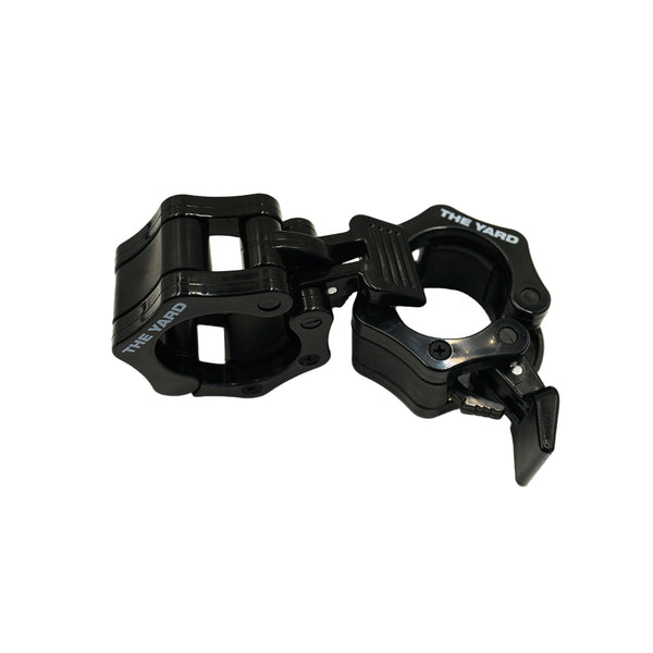 The SMAI The Yard - Barbell - Easy Lock 50mm Collars (Pair) feature "THE YARD" in white and offer a secure, easy-to-use fit for Olympic bars, allowing quick, hassle-free adjustments. Shown open on a plain white background.