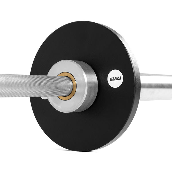 Close-up of SMAI Calibrated Weight Plates - 2.5kg (Pair) with a silver center ring on a barbell. The textured, knurled grip bar and bold SMAI logo highlight these durable, precision cast iron powerlifting plates.
