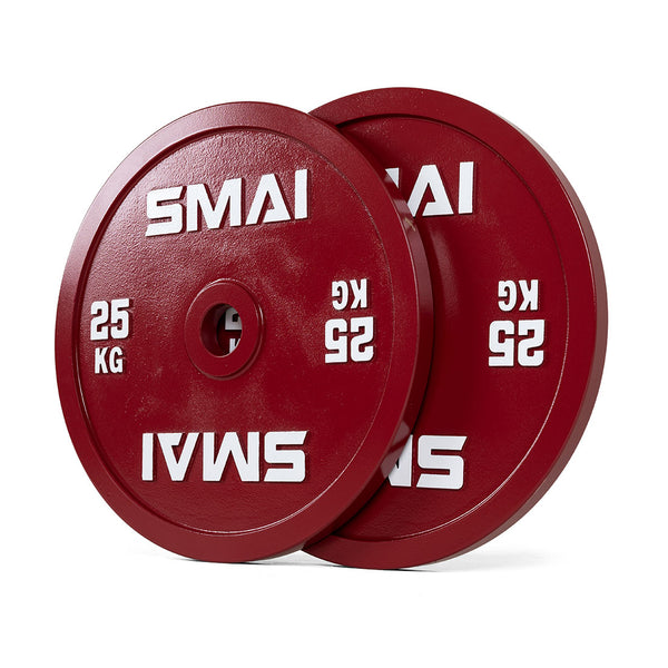 A pair of SMAI 25kg calibrated weight plates, red and round with "SMAI" in white lettering, are stacked together with one slightly in front.