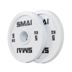A pair of SMAI Calibrated Weight Plates - 5kg each, white with "SMAI" and "5 KG" in black text, are standing upright and leaning against each other on a white background.